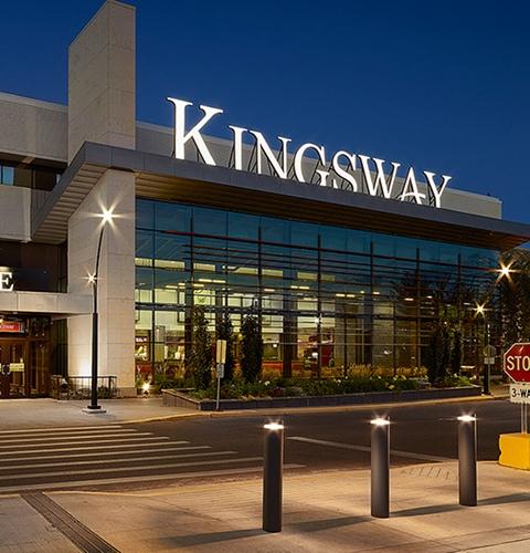 Illuminated Kingsway mall entrance and glass facade at night